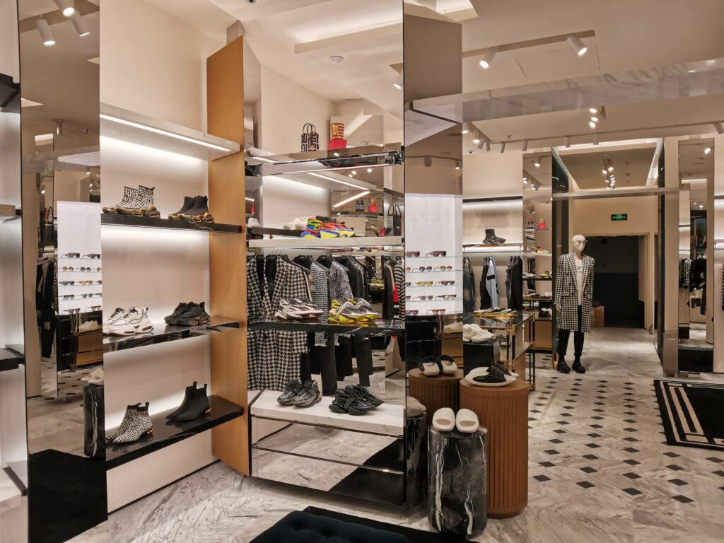 BALMAIN store interior - fashion clothes display showcases and racks in the store