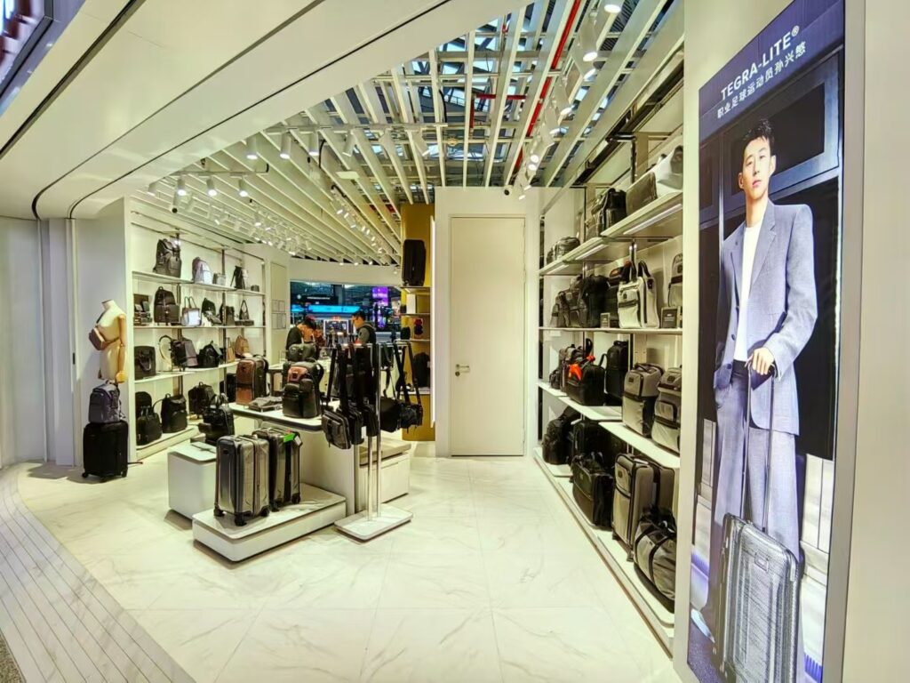 TUMI store interior with fashion display showcases and shelves