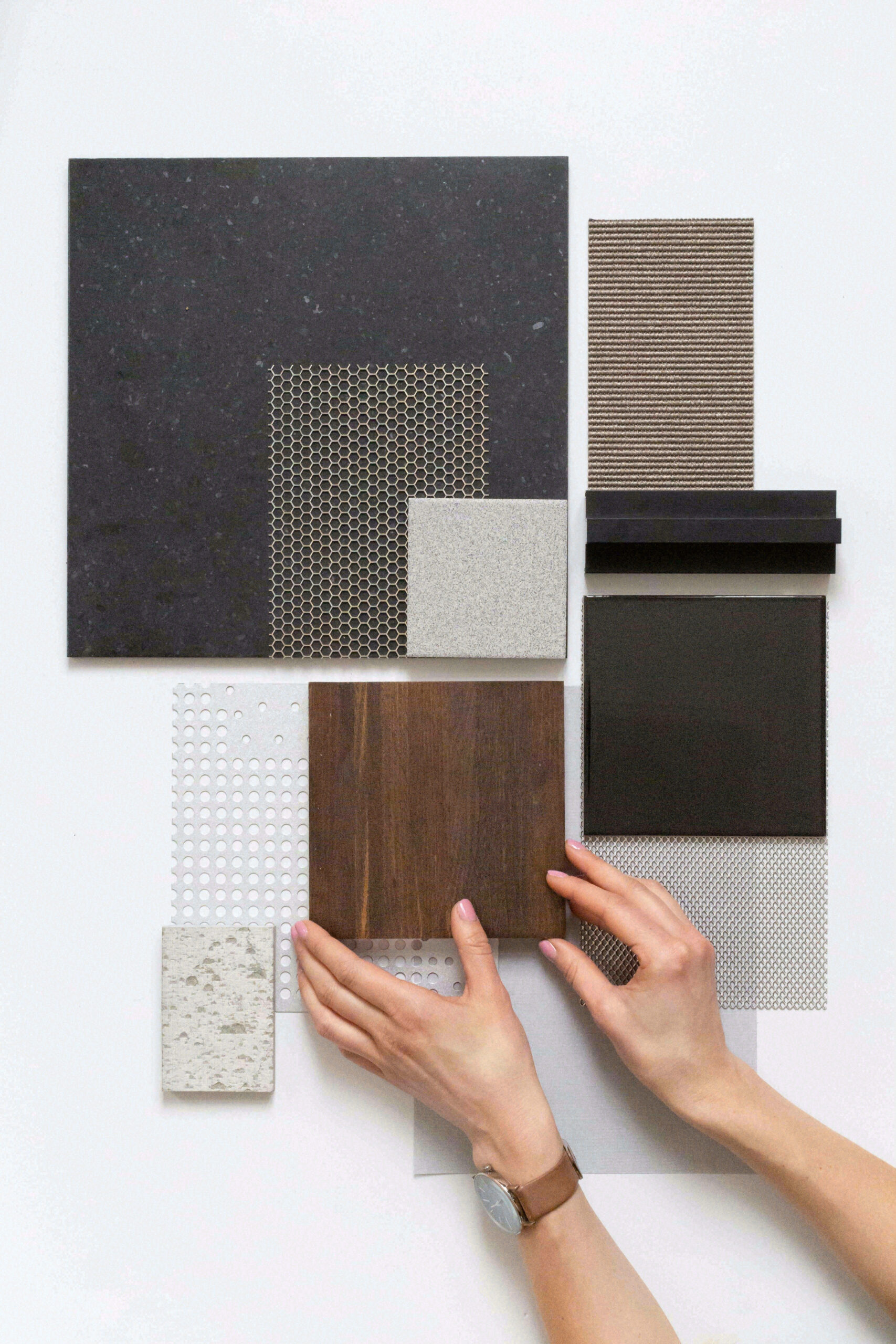 Displaying a variety of materials on the table to showcase custom finish ability